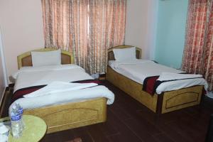 Una cama o camas en una habitación de Hotel Mudkhu Durbar