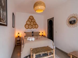 a bedroom with a large bed and a table at Riad Nelia De Marrakech Hotel Boutique & Spa in Marrakech