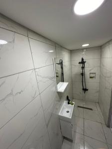 a white bathroom with a sink and a mirror at REYNA OTEL in Yıldırım