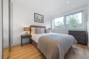Contemporary 1 Bedroom Apartment in East Grinstead في إيست غرينستيد: غرفة نوم بيضاء بها سرير ونافذة