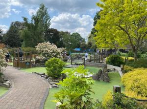 a garden with a park with a playground and trees at Sensational 2BR wViews & Balcony in Wandsworth in London