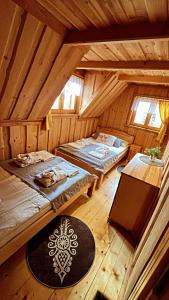 um quarto no sótão com 2 camas e uma mesa em Domek w Górach- Bacówka u Dudka em Nowy Targ