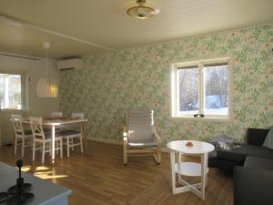 a living room with a couch and a table at Villa Indalsälven in Hammarstrand