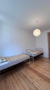 Duas camas num quarto com pisos em madeira em Persati View em Kutaisi