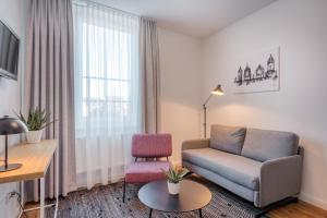 a living room with a couch and a chair at Hotel Bad Minden in Minden