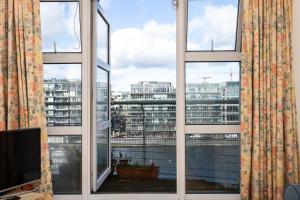 a window with a view of a city at Flat w/ Balcony & Canal view - 4min to station in Dublin