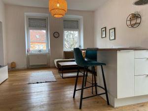 eine Küche mit einer Theke und einem Stuhl in einem Zimmer in der Unterkunft Altbau mit Flair in Klagenfurt am Wörthersee
