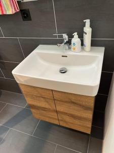 a bathroom sink with two soap bottles on it at Studio an traumhafter Lage in Sigriswil