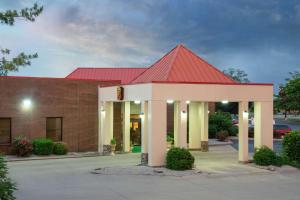 a large brick building with a red roof at Super 8 by Wyndham Harrison OH in Harrison