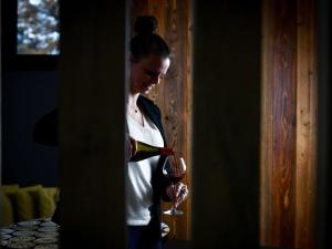 een vrouw houdt een glas wijn vast bij ibis Beaune La Ferme Aux Vins in Beaune