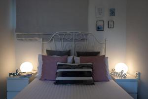 a bedroom with a bed with purple and pink pillows at Elysian Studio in Kalamata
