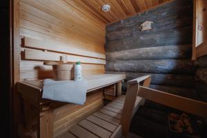 a wooden sauna with a bench and a sink at Kelokurki in Levi