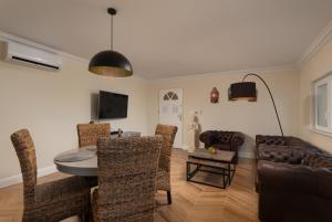 a living room with a table and chairs and a couch at Villa Suartini Viganj Pool or Jakuzzi in Viganj
