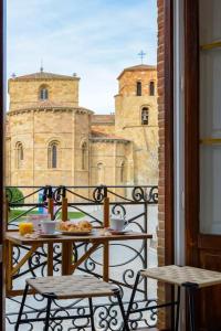 a balcony with a table and chairs and a view of a building at Balcony of the Wall I 1min to avila's ALCAZAR in Avila