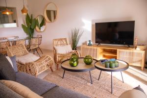 a living room with a couch and chairs and a television at NEW! Quinta do Lago Golfside Retreat in Quinta do Lago