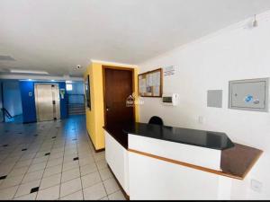 a lobby of a hospital with a reception desk at Departamento a 20 metros do mar. in Florianópolis