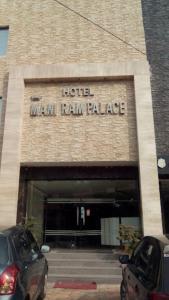 two cars parked in front of a hotel van ram palace at Hotel Mani Ram Palace,Agra in Agra