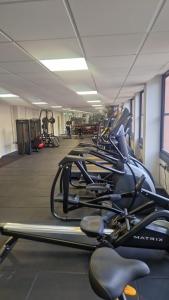 a row of exercise bikes lined up in a gym at Modern 1 Bedroom Apartment in East Grinstead in East Grinstead