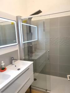 a bathroom with a glass shower and a sink at Villa Tassigny in Aix-en-Provence +36 photos