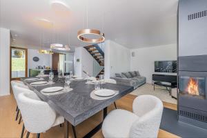 a dining room and living room with a table and chairs at Luxury architecture chalet with view and wellness in Bludenz