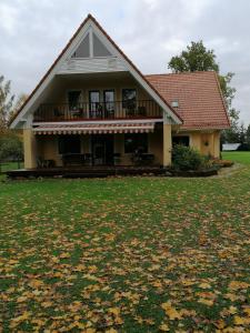 a house with a large yard in front of it at Villa River Rose in Jõesuu