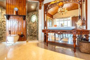 a bathroom with a sink and a toilet in a room at SaffronStays Naiintara in Nainital
