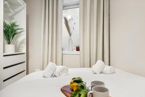 a white bedroom with two beds and a tray of fruit at King bed - Renovated 2024 - 2BR Behind Bryggen in Bergen