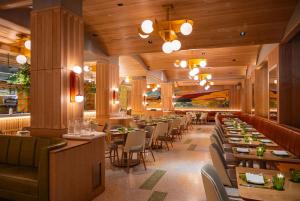 a restaurant with tables and chairs in a room at Hilton Club The Quin New York in New York