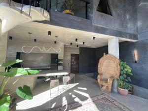 a living room with a table and a chair at Happiness Kulambo Villa El Nido in El Nido