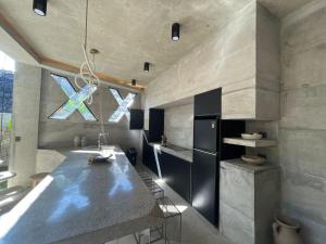 a kitchen with a large counter and a sink at Happiness Kulambo Villa El Nido in El Nido +30 photos