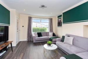 a living room with two couches and a tv at Stylish 3 bed Edinburgh Abode - Parking and Garden in Edinburgh
