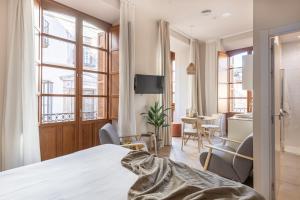 Televízia a/alebo spoločenská miestnosť v ubytovaní Apartamentos Líbere Málaga Teatro Romano