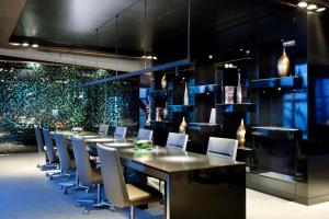 a conference room with a long table and chairs at Hyatt Regency Barcelona Tower in Hospitalet de Llobregat +69 photos