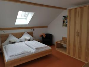 a bedroom with a bed and a skylight at Gästehaus Eisenhut in Walzenhausen +34 photos