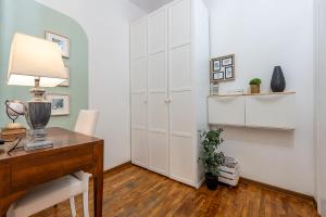 a home office with a desk and a white wall at Romantic apt in Historic Center - Egyptian museum in Turin