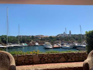 a view of a marina with boats in the water at Sardegna Beach Cala Reale in Santa Marinella
