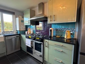 a kitchen with a stove top oven in a kitchen at Blackwater Terrace Witham 