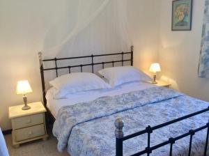 a bedroom with a large bed with two night stands at B&B Maison Brora in Lorgues