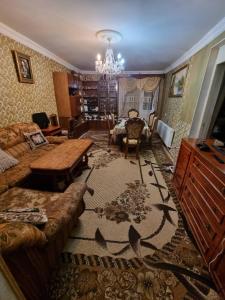 a living room with a couch and a table at Аренда дома in Gyumri