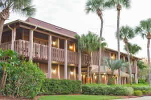 a large house with palm trees in front of it at Hilton Vacation Club Polynesian Isles Kissimmee in Kissimmee