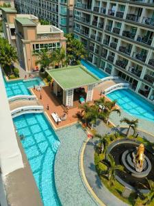 an aerial view of a large swimming pool with a tennis court at dusit grand park 2 pool view in Jomtien Beach