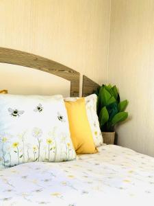 a bedroom with a bed with pillows and a bed with a bedspread with at Dunlin Retreat in Flamborough