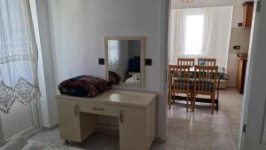 a room with a table with a mirror and a crib at California Apart Otel in Oludeniz