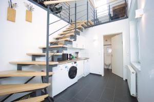 a laundry room with a washer and dryer and stairs at HejU- Haus im Grünen in Rosengarten