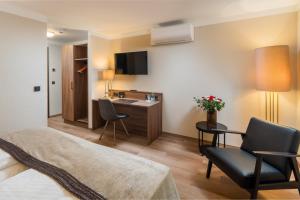 Et tv og/eller underholdning på Best Western Plus Hotel Excelsior