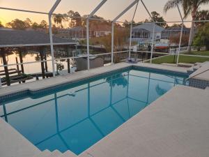 a swimming pool at a resort at Peaceful Waterfront Pool Home home in Palm Coast