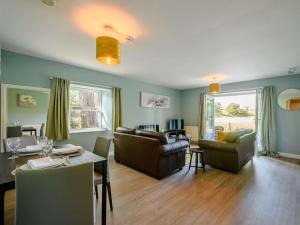 a living room with a couch and a table and chairs at 1 Bed in Sanquhar 89401 in Sanquhar