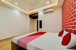 a bedroom with a bed and a brick wall at Vachan Garden And Resort in Bhopal
