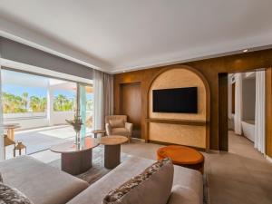 a living room with a couch and a tv at Sofitel Agadir Royal Bay Resort in Agadir