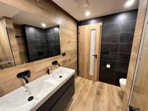 a bathroom with a sink and a toilet and a mirror at Apartmány BARTH Holiday - rezidence Máj in Pec pod Sněžkou +33 photos